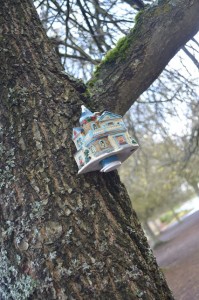 This geocache is fashioned onto a tree in Tacoma in a busy shopping plaza. Inside this porcelain house is a logbook for geocachers to sign.