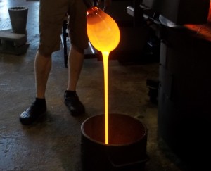 The glass blown pumpkin begins to take form after repeated heating and spinning.