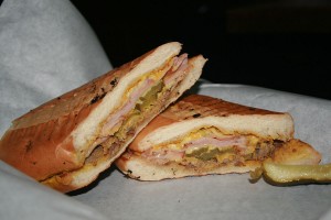 The hot pressed Cuban at Peterson Bros. 1111 has layers of slow-roasted pork shoulder and black forest ham separated by pickles and melted cheese.