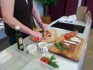 Students learn to make pizza during a cooking class at Marlene's Market.