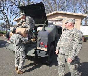 Soldiers use two Humvees to deliver food donation to Tillicum food bank.