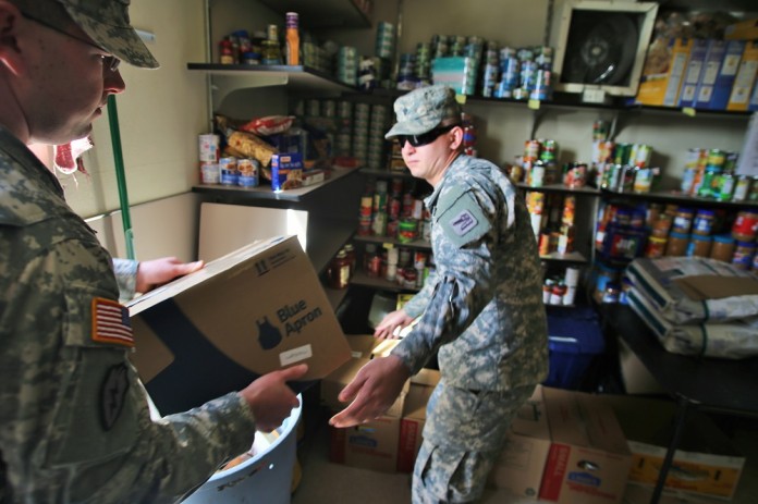 soldiers deliver food to Tillicum food bank Soldiers unload food at Tillicum food bank.