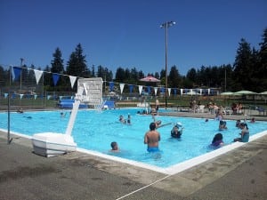 Residents enjoy a cool swim during the summer heat at the community pool in Fircrest outside Tacoma.  Photo credit: Sonia Garza.