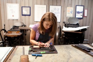 Former student Caitlin Harris setting type at the Elliott Press. Harris went on to found Wheelhouse Press in Portland, Oregon. Photo courtesy: PLU School of Arts and Communication.