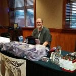 ufo summit man at alchemy table